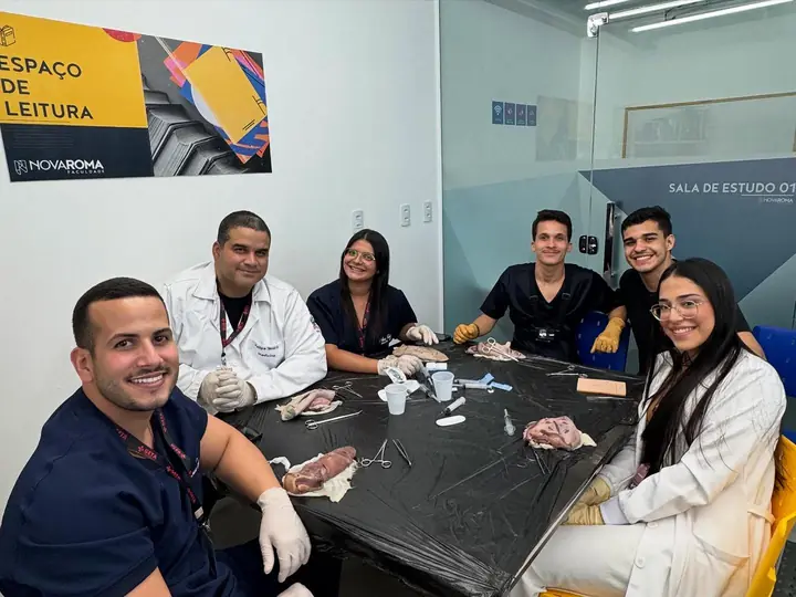 Alunos em bancada de prática de sutura